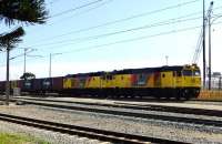 Two DC Class locos head a very long northbound container train along the south bank of the Swan River on the single mixed gauge track. Aurizon is actually QR National Limited (formerly part of Queensland Rail) and is the largest rail-freight company in Australia. The narrow gauge lines in the foreground are Transperth Fremantle to Perth tracks and Fremantle passenger station is just off scene to the left.<br><br>[Colin Miller 06/10/2014]