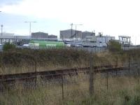 'Greenergy' bogie tank wagons in the loading facility at the Port Clarence terminal on 15 October. In the foreground is the disused branch running north towards the Seal Sands chemical complex.<br><br>[David Pesterfield 15/10/2014]