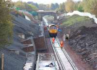 The Borders Railway tracklaying team in action mid morning on 17 October 2014 just south of Newtongrange station. The train is being propelled by GBRf 66736. <br><br>[John Furnevel 17/10/2014]