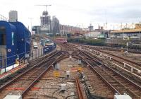 View east from Poplar DLR station on 18 October 2014. The track on the left leads over the flyover to Beckton and Woolwich; the track on the right to Stratford. The scissors crossing does not seem to be used by regular services. Meantime, the construction work continues in the background... [see image 23049]. <br><br>[John Thorn 18/10/2014]
