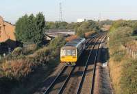 Rebuilding the Blackpool line bridges for electrification has created some new (but probably temporary) vantage points, including this one at Darkinson Lane near Lea Road. 142047 heads west on a Manchester Victoria to Blackpool North service on 2nd October. The white structure beyond the trees is part of the nuclear fuel complex at Salwick. <br><br>[Mark Bartlett 02/10/2014]