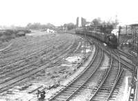 67675 about to run through Sunnyside Junction in August 1961 with a North Clyde service for Airdrie. The train is about to pass below Gartsherrie Road to reach its next stop at Coatbridge Sunnyside station. [Editor's note: The area occupied by the lifted sidings on the left is now part of Summerlee Industrial Heritage Museum]  [See image 26202] <br><br>[G H Robin collection by courtesy of the Mitchell Library, Glasgow 01/08/1961]