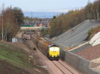 Early afternoon sunshine catches the front of Freightliner 66605 with a Borders Railway ballast train at Newtongrange on 24 October 2014. Sister locomotive 66602 is on the other end of the train. View north towards the Firth of Forth.<br><br>[John Furnevel 24/10/2014]