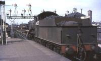 Churchward 2-6-0 6309 stands at at signals at the north end of the down platform at Oxford station on 27 August 1964 while 6154 passes with a southbound freight.<br><br>[John Robin //]