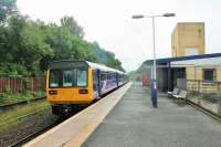 A Sprinter/Pacer combination on a Wigan Wallgate service departs from the surviving island platform at Rochdale in July 2013. To the left of the train another long disused platform can be seen, a reminder of the days when the station was a much larger structure than that surviving today. [See image 48303]  <br><br>[Mark Bartlett 31/07/2013]