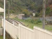 A long lens view from the footbridge at the east end of Barry Island station in October 2014. In the right background is the closed off north portal of the railway tunnel that gave access to Barry Pier station, from where ferries once operated to Weston-super-Mare. [See image 31352]<br><br>[David Pesterfield 30/10/2014]