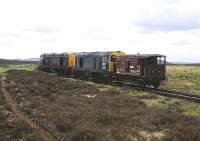 A pair of class 20s approaching Polkemmet Colliery off the moor on 26 May 1982. The locomotives are 20078+20063 (nearest). Given the poor state of the track at that time I'm surprised the driver didn't get seasick.<br><br>[Peter Todd 26/05/1982]