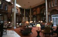 The Peacock Alley lounge area of the former Caledonian Hotel which stood alongside Edinburgh's Princes Street station, photographed in November 2014. The white door stands at the original pedestrian entrance to the station concourse. Princes Street station closed in 1965 and the Caledonian is now a Waldorf Astoria hotel. [See image 29019] <br><br>[Colin McDonald 01/11/2014]