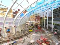 A tram heading for Bury threads its way though the single line section from Shudehill on 31 October, with construction of the striking new roof of Manchester Victoria at an advanced stage. <br><br>[Malcolm Chattwood 31/10/2014]