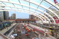 A Metrolink tram on a Bury service heads though the construction site which will re-establish Manchester Victoria as a station on the system when new island platforms are completed.  To the left Platform 1 on the main network is awaiting the arrival of a train from Leeds which will terminate here.<br><br>[Malcolm Chattwood 31/10/2014]