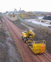 A track machine heading south past the former Lady Victoria Colliery, Newtongrange, on 6th November 2014 [see Image 40800].<br><br>[David Spaven 06/11/2014]