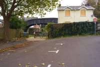 Looking north from the site of Blandford Forum station on 22 October 2014. Most of the site has been redeveloped with housing and a car park but there are tell tale signs around of former use. On the right with the recently boarded up windows is the old station house, while to the left is the footbridge over the trackbed towards Sturminster Newton (now part of the North Dorset Trailway). Beyond the 5 bar gate is a short length of track and buffer stops. [Ref query 4248]<br><br>[John McIntyre 22/10/2014]