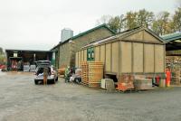 The old goods shed and the concrete provender store at Sedbergh have been used by Dawsons merchants since they railway yard closed in 1964. The mainline ran to the right of the buildings but a short section of old siding is still in place in front of the large sliding door. Local passenger services ceased in 1954 but school specials and diversions continued into the 1960s. The passenger station survives but under different ownership and is not accessible. Picture taken with kind permission of site owner. <br><br>[Mark Bartlett 28/10/2014]