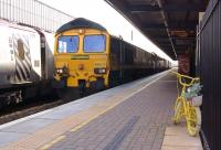 Freightliner 66513 runs north through Warrington Bank Quay on 4 November 2014 heading for Hunterston with empty coal wagons from Fiddlers Ferry Power Station. [The photographer wishes to make it clear that it is not his bicycle leaning against the railings but one left over from the <I>Tour de France</I>.]<br><br>[John McIntyre 04/11/2014]