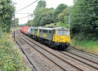 Two elderly Class 86 electrics, still in front line Freightliner service, head south at Barton and Broughton with Coatbridge to Crewe containers on 30th July 2014. 86609 was the second of the class and emerged from Doncaster in 1965 as E3102, while trailing loco 86604 followed as E3103.  <br><br>[Mark Bartlett 30/07/2014]