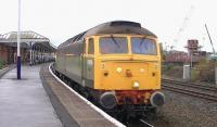 D1916 in two tone green livery passing through Kilmarnock station on 12 November 2014. The GBRf class 47 was taking new wagons from Barclay works to Doncaster.<br><br>[Ken Browne 12/11/2014]