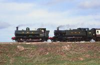 GWR 2-6-2T 6106 double heads 0-6-0PT 7752 with a train near Winchcombe on 12 August 1990.<br><br>[Peter Todd 12/08/1990]