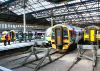 Sunshine on a colourful Waverley west end in June 2002, with various DMUs at the buffer stops. The predominant livery is that applied by National Express Group, the ScotRail franchise holder at the time. <br><br>[John Furnevel 10/06/2002]