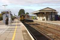 A Weymouth service departs from Castle Cary on 25 October 2014 and as the feather on the signal indicates the train is about to take the Heart of Wessex line to Yeovil Pen Mill. For the same view nearly 30 years earlier [see image 13435].<br><br>[John McIntyre 25/10/2014]