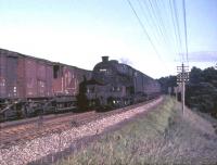 Trains meet on the WCML near Braidwood, South Lanarkshire, on 16 July 1965. Jubilee 45698 <I>Mars</I>, heading towards Glasgow with a train from Manchester, passes an unidentified up freight.    <br><br>[John Robin 16/07/1965]