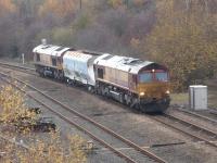 66102 leads in top and tail mode <br>
with 66007 as they run east towards Storrs Hill Road after extracting a long stored former National Power HKA coal wagon from Healey Mills Marshalling Yard. The wagon was to be moved by road to a Marcroft depot for refurbishment pending return to traffic.<br><br>[David Pesterfield 17/11/2014]