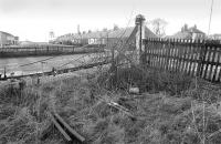 Looking south over the A955 at East Wemyss on 1 January 1986. Remnants of the Wemyss Private Railway level crossing with the headframe of Michael Colliery in the background.<br><br>[Bill Roberton 01/01/1986]