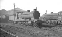 Various 2-8-0 freight locomotives in the shed yard at Doncaster, thought to be around 1960. An unidentified class O4, which looks to have been involved in some over-enthusiastic shunting, stands in the centre, while 02 63969, minus a pair of driving wheels, is on the right.<br><br>[K A Gray //1960]