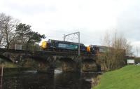 A light load, of just one four wheeled container wagon, for DRS 37605 and 37059 as they cross the River Wyre at Scorton on 22nd November. This Saturday working from Sellafield to Crewe was routed via Maryport and Shap rather than the Furness line.  <br><br>[Mark Bartlett 22/11/2014]