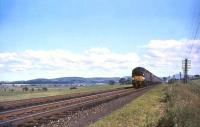 An EE Type 4 with the down <I>Royal Scot</I> passing the site of Pettinain signal box in the summer of 1965 on the southern approach to Carstairs.<br><br>[John Robin 17/07/1965]