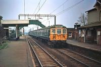 A 12 coach Class 312 Clacton/Walton to Liverpool Street formation passes Alresford (Essex) on 21st November 1976. At the time, these 'outer suburban' units were fairly new to the line and a reasonable alternative to the well-liked Class 309 units, which were being released from duty for refurbishment.<br><br>[Mark Dufton 21/11/1976]