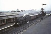 Carlisle Kingmoor's Black 5 no 45018 with a down goods at Carstairs station on 15 July 1966. Various parts of 64D shed can be seen projecting above the station roof.<br><br>[John Robin 15/07/1966]