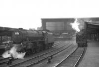 Black 5 45218 stands ready to take over a Blackpool train at Carlisle on 27 June 1964. The train has just arrived at platform 4 behind Britannia Pacific 70007 <I>Coeur-de-Lion</I>. <br><br>[John Robin 27/06/1964]