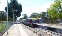 On 3 October 2014 a Vicrail Vlocity DMU, with all headlights blazing, hammers through the wayside station of Macedon on its way from Bendigo to Melbourne. As can be seen from the traditional name board, this station has a local support group.<br><br>[Colin Miller 03/10/2014]