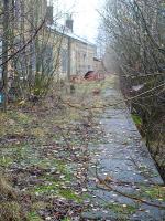 View south along the former Woodhead Line eastbound platform at Penistone in November 2014. Platform edging stones are still in situ  and, other than a few shrubs and some grass growth, the platform is little changed from when the line closed 33 long years ago in 1981.<br><br>[David Pesterfield 28/11/2014]