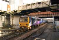 A Northern service from Leeds arrives at Manchester Victoria platform 4 on 29 November 2014. Electrification at the west end of Victoria is well advanced but there are fewer clues at the east end of the station with a pair of stanchions visible in this view.<br><br>[John McIntyre 29/11/2014]