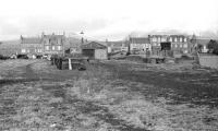 Track level view over the former Crieff goods yard on 17 March 1970 looking towards King Street. The deep glacial trench of Glen Turret is prominent beyond the roof of the old goods shed.<br><br>[Bill Jamieson 17/03/1970]