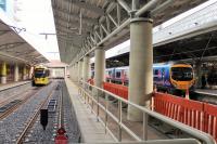 The new Metrolink platforms at Manchester Airport from the buffer stops. When opened in 1993 the station had two platforms but has been greatly expanded since 2008. Of the most recent platforms only No.6 was in use on 2 December with Tram 3089 waiting to return to Cornbrook. The new main line platform 4 to the right was nearing completion, with TPE 185121 waiting at platform 3 on a Blackpool North service.  <br><br>[Mark Bartlett 02/12/2014]