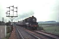 A Morecambe train heading south on the WCML seen shortly after passing Strawfrank Junction (now Carstairs South) in the summer of 1965, with the signal box visible above the road bridge. The locomotive is Kingmoor Black 5 no 44790. <br><br>[John Robin 17/07/1965]