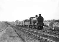 Ex-Caledonian 0-6-0 no 57652 approaching Milngavie Junction (Westerton Junction from 1959) at the south end of the Milngavie branch with the branch goods on 24 May 1957. The containers are thought to contain paper from the Ellangowan Mill. [Ref query 6552]<br><br>[G H Robin collection by courtesy of the Mitchell Library, Glasgow 24/05/1957]