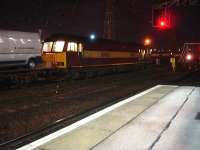 Early evening on 3 December with 60035 standing on the goods line opposite platform 8 at Doncaster, attached to the north end of a rake of wagons containing new Peugeot & Citroen vans. Contrary to expectations the train moved off heading south, not north, with the Class 60 tailing the rake, possibly heading to Belmont Yard or direct to Doncaster Europort for off-loading.    <br><br>[David Pesterfield 03/12/2014]