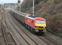 Despite the storms battering the UK on 11th December the Christmas mail was still getting through. DBS 90036 <I>Driver Jack Mills</I> was still bright and shiny following its naming ceremony at Crewe the previous week as it hauled a rake of cargo waggons through Hest Bank on the Shieldmuir to Warrington return trip that has supplemented the usual postals during December. <br><br>[Mark Bartlett 11/12/2014]