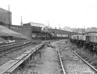 Ivatt 4MT 2-6-0 43138 at Sunnyside Junction with a goods train on 26 August 1958, having arrived via the freight only line from Whifflet. The platforms of Coatbridge Sunnyside station are visible through the road bridge, above which stands the old booking office.<br><br>[G H Robin collection by courtesy of the Mitchell Library, Glasgow 26/08/1958]