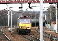 EWS 60002 gets the road north through Carstairs on 2 December 2004 with the returning Dalston - Grangemouth empties.<br><br>[John Furnevel 02/12/2004]