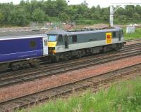 Early one morning. EWS 90022 <I>'Freight Connection'</I> stands well beyond the down platform at Carstairs at 0620 on 11 July 2006, having just brought in the 15 coach Caledonian Sleeper from Euston. Back in the station the train is being divided between coaches 8 and 9, following which 90022 will continue to Glasgow Central and the rear portion will head for Edinburgh Waverley behind EWS 37405 [see image 9871].     <br><br>[John Furnevel 11/07/2006]