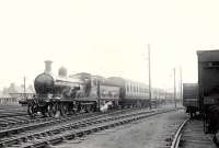 GNSR D40 4-4-0 62275 <I>Sir David Stewart</I> about to pass what was then its home shed at Kittybrewster with a special train for Macduff on Saturday 7 July 1951.<br><br>[G H Robin collection by courtesy of the Mitchell Library, Glasgow 07/07/1951]