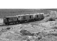 20063 and 20078 cross a minor road on Polkemmet Moor heading for the colliery exchange sidings, on 26 May 1982.  [See image 25094]<br><br>[Bill Roberton 26/05/1982]