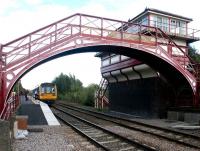 Looking east through the station footbridge at Haltwhistle towards the staggered Newcastle bound platform on 21 September 2003 where a train is about to leave for Middlesbrough.  <br><br>[John Furnevel 21/09/2003]