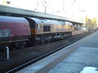 EWS liveried 66056 runs north through Newcastle Central with a rake of twenty three empty HHA coal wagons on 3 December 2014.<br><br>[David Pesterfield 03/12/2014]