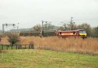 The last <I>Christmas Postal Extra</I> of 2014 heads south behind DBS electric 90035. The train is passing the Hest Bank livery stables approaching the level crossing on 23rd December. The return trip from Sheildmuir to Warrington has been made on most weekdays in December. <br><br>[Mark Bartlett 23/12/2014]