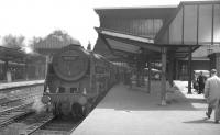 Britannia 70033 <I>Charles Dickens</I> has just backed onto the 9.25am Crewe - Aberdeen at Carlisle platform 3 on Saturday 26 June 1965. The Pacific had been reallocated to Kingmoor from Crewe South during the previous week and would spend the rest of its operational life at 12A until final withdrawal in July 1967.<br><br>[K A Gray 26/06/1965]